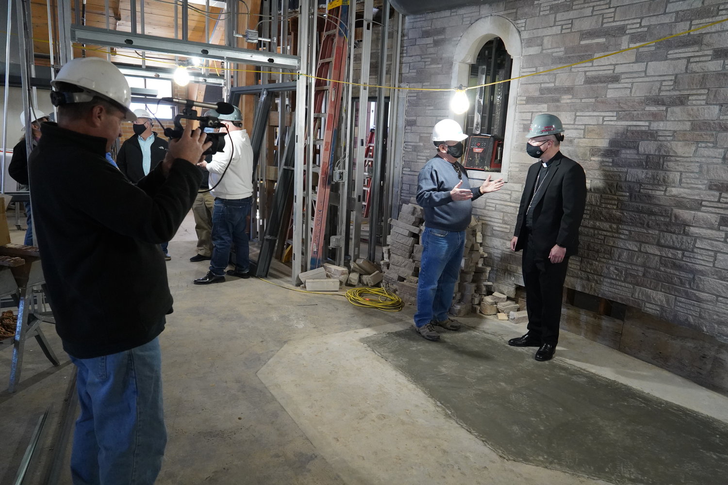 Bishop W. Shawn McKnight visits with retired local contractor Jim Wisch, a member of the CCCNMO board of directors and the Shikles redevelopment planning committee. The bishop is standing where the altar for the former La Salette Seminary Chapel once stood.